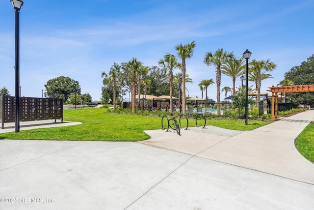 surrounding community featuring mail area, fence, and a lawn