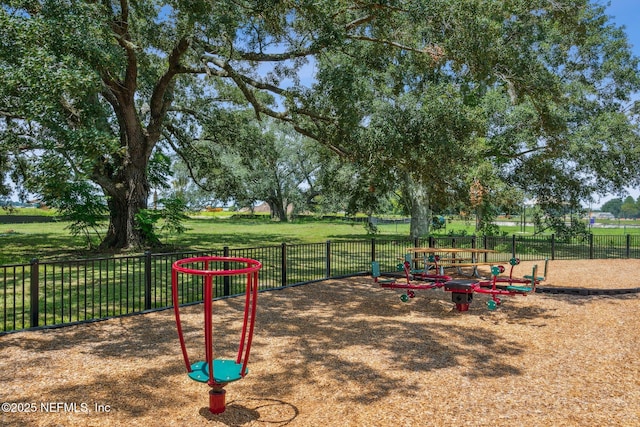 view of playground with fence and a yard