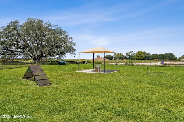 view of play area with a lawn and fence