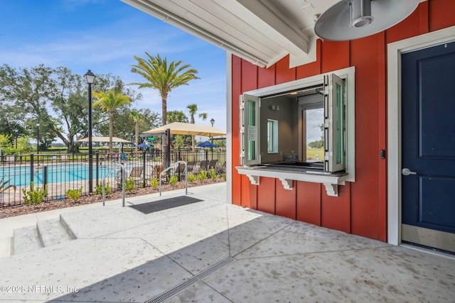 view of patio featuring fence and a community pool