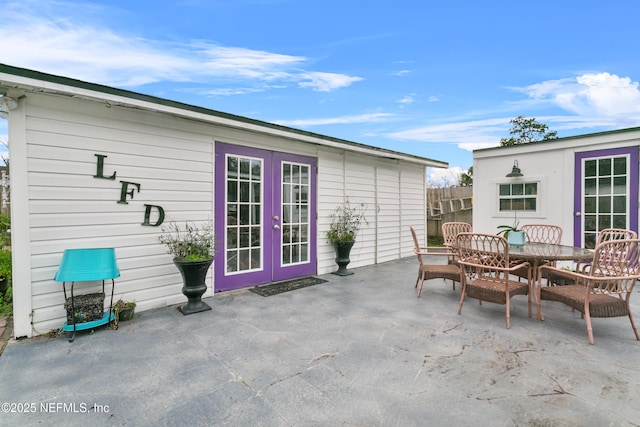 view of patio / terrace featuring fence, outdoor dining area, and french doors