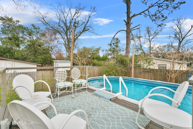 view of pool with a fenced backyard, a fenced in pool, and a patio