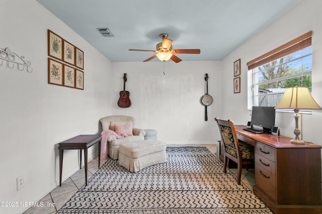 home office featuring ceiling fan, visible vents, baseboards, and light tile patterned flooring