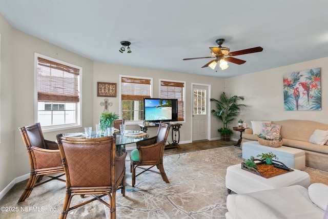 interior space featuring ceiling fan and baseboards