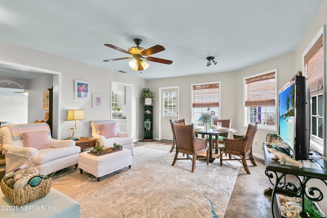 living room featuring light carpet, ceiling fan, visible vents, and baseboards