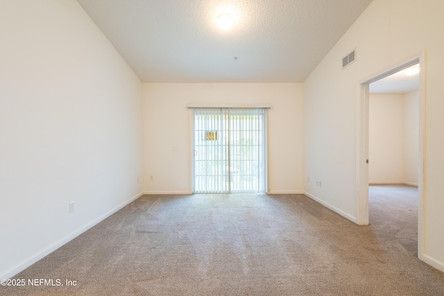 4908 Key Lime Dr Unit 301, Jacksonville, FL 32256 - spare room with visible vents, baseboards, carpet, and a textured ceiling