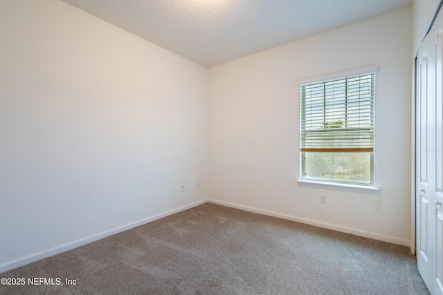 4908 Key Lime Dr Unit 301, Jacksonville, FL 32256 - carpeted spare room featuring baseboards and a textured ceiling