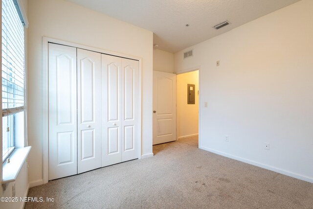 4908 Key Lime Dr Unit 301, Jacksonville, FL 32256 - unfurnished bedroom with visible vents, baseboards, a closet, and carpet flooring