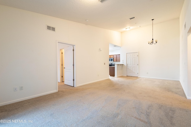 4908 Key Lime Dr Unit 301, Jacksonville, FL 32256 - unfurnished room featuring visible vents, baseboards, a chandelier, light carpet, and high vaulted ceiling