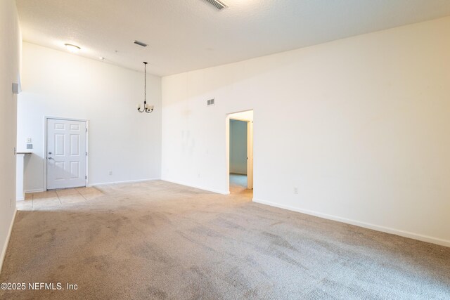 4908 Key Lime Dr Unit 301, Jacksonville, FL 32256 - unfurnished room featuring visible vents, baseboards, high vaulted ceiling, light carpet, and a textured ceiling