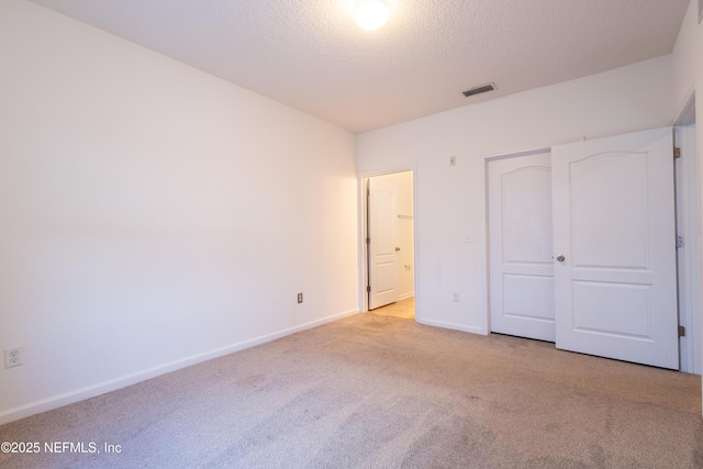 4908 Key Lime Dr Unit 301, Jacksonville, FL 32256 - unfurnished bedroom with carpet flooring, baseboards, visible vents, and a textured ceiling