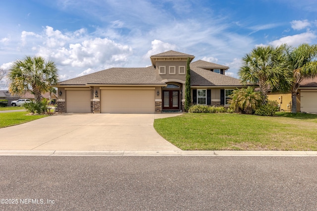 view of front of property featuring french doors, stucco siding, concrete driveway, a front yard, and a garage