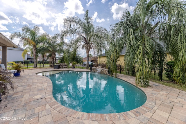 view of swimming pool with a patio, fence, and a fenced in pool