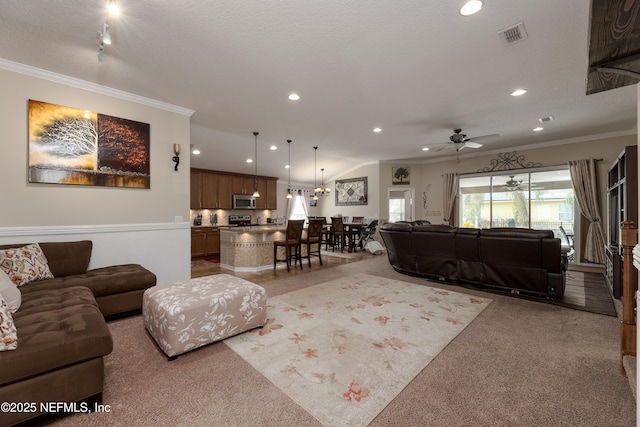 living room featuring a textured ceiling, recessed lighting, light colored carpet, visible vents, and crown molding