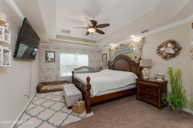 carpeted bedroom featuring crown molding, a raised ceiling, visible vents, and ceiling fan