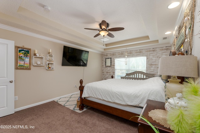 carpeted bedroom with baseboards, visible vents, a tray ceiling, and a textured ceiling