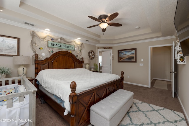 bedroom featuring baseboards, visible vents, a raised ceiling, ornamental molding, and carpet flooring