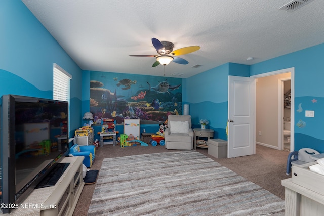 carpeted bedroom with visible vents, ceiling fan, a textured ceiling, and baseboards