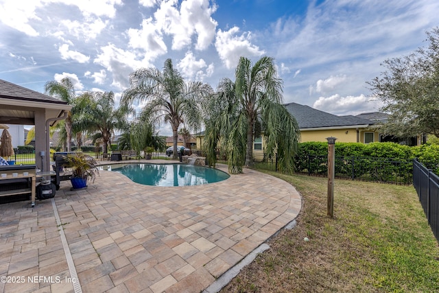 view of swimming pool with a patio area, fence, a fenced in pool, and a yard