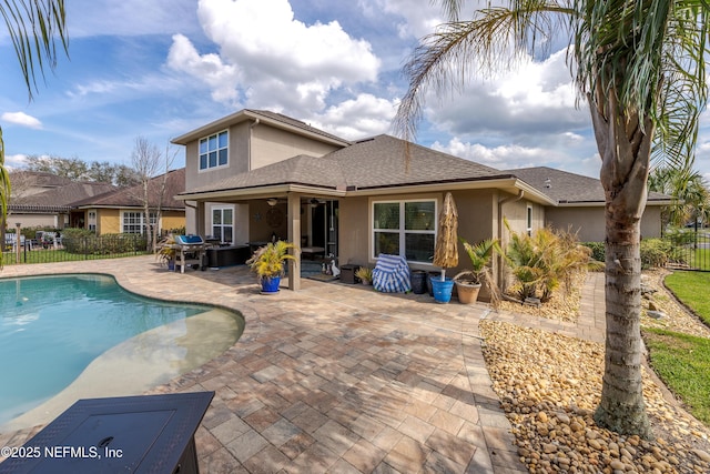 view of pool featuring a fenced in pool, fence, ceiling fan, and a patio