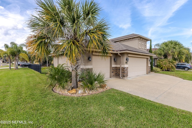 view of property exterior featuring fence, stone siding, driveway, a lawn, and stucco siding