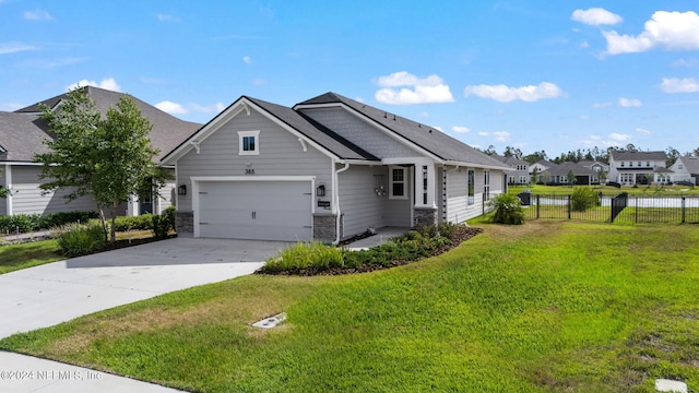 view of front facade featuring a garage, fence, driveway, a residential view, and a front lawn