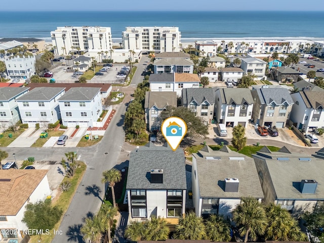 drone / aerial view featuring a water view and a residential view