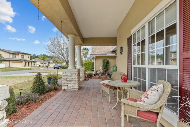 view of patio / terrace with a porch and a residential view