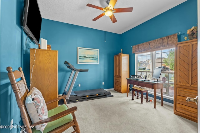 interior space with carpet, baseboards, ceiling fan, and a textured ceiling