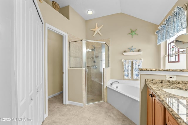 bathroom featuring lofted ceiling, a garden tub, a shower stall, and vanity