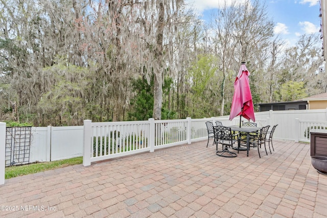 view of patio with fence and outdoor dining area