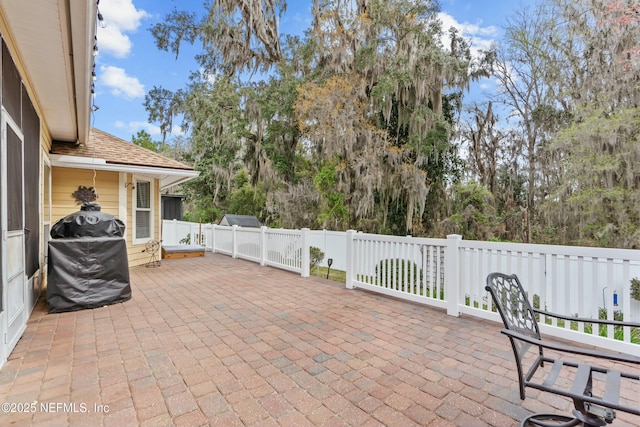 view of patio with grilling area and a fenced backyard