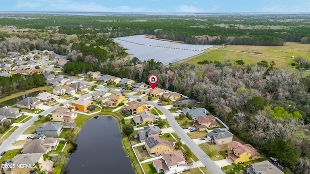 drone / aerial view with a water view and a residential view