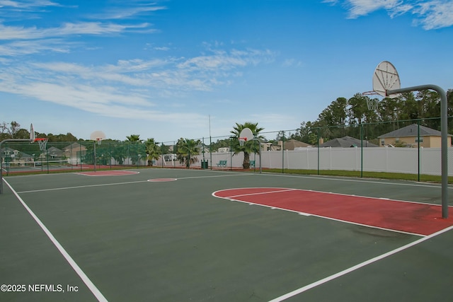 view of basketball court with community basketball court and fence