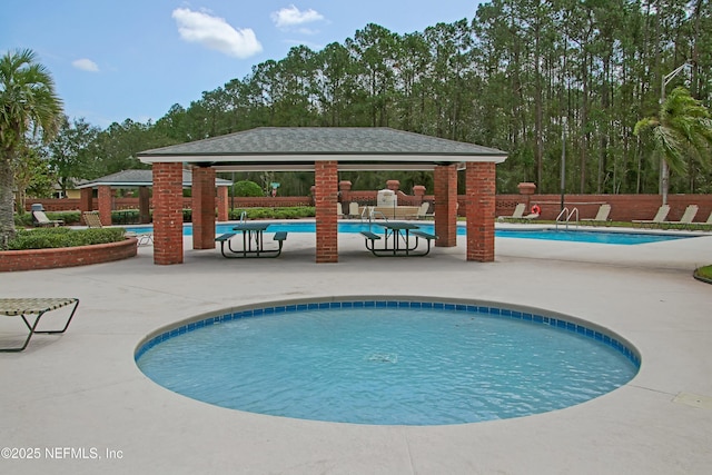 pool featuring a patio area, fence, and a gazebo