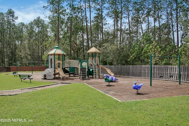 community jungle gym with fence and a lawn