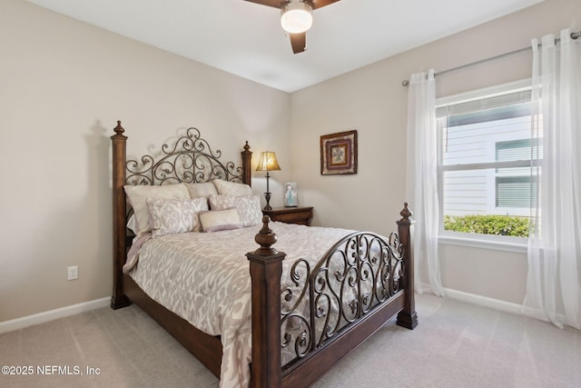 bedroom with a ceiling fan, baseboards, and carpet flooring