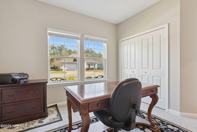 office area with light carpet and baseboards