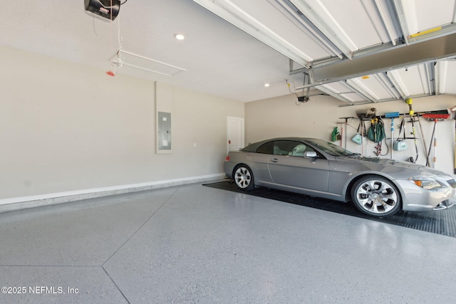 garage with electric panel, baseboards, and a garage door opener