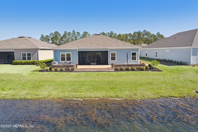 back of property with a sunroom and a yard