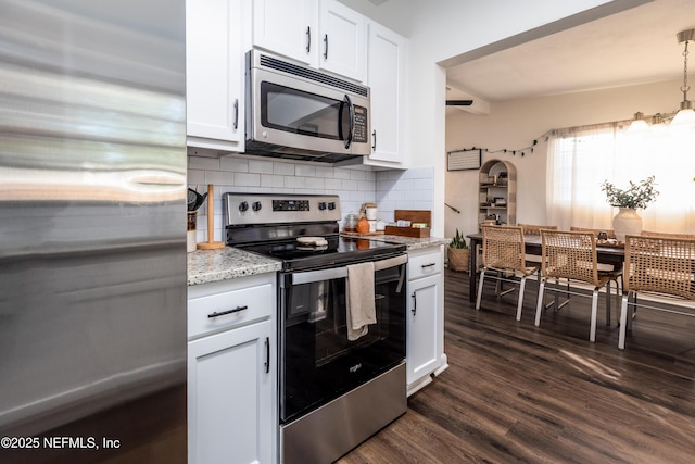 kitchen with appliances with stainless steel finishes, dark wood finished floors, and white cabinetry