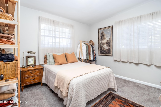 bedroom featuring carpet and baseboards