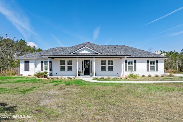 single story home with covered porch, a shingled roof, and a front lawn