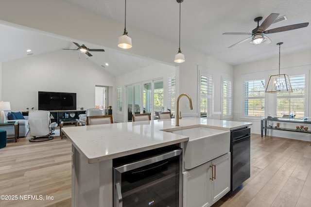 kitchen featuring light wood-style floors, beverage cooler, plenty of natural light, and open floor plan