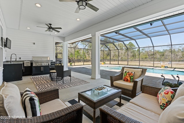 view of patio / terrace featuring outdoor lounge area, a grill, exterior kitchen, a lanai, and an outdoor pool