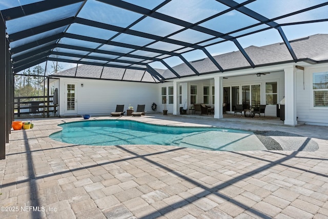 outdoor pool featuring a ceiling fan, a lanai, and a patio area