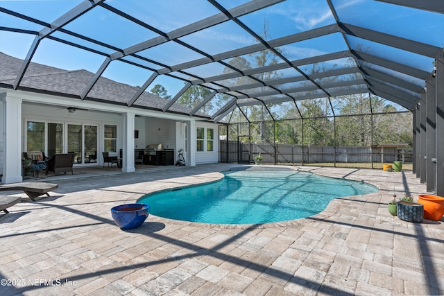 view of swimming pool featuring a fenced in pool, grilling area, glass enclosure, a patio area, and fence