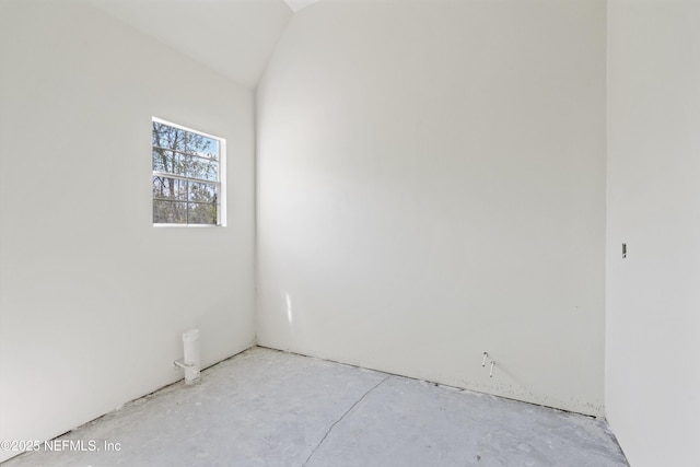 unfurnished room with lofted ceiling