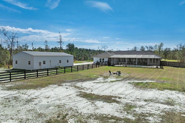 view of front facade with fence, a front lawn, and an outdoor structure