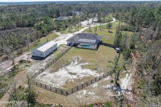 birds eye view of property featuring a rural view and a forest view